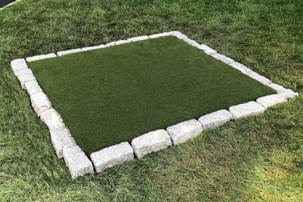 Naperville Tee box made of synthetic grass surrounded by stone border